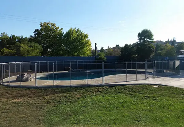 Removable Black Mesh Fencing with Gray Poles in Merced