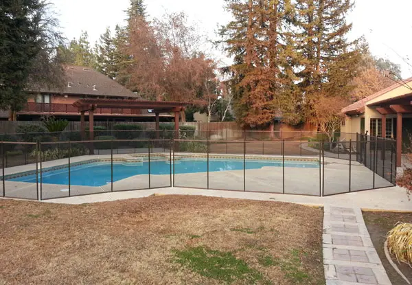 Transparent Mesh Pool Fencing with Brown Trim in Kingsburg